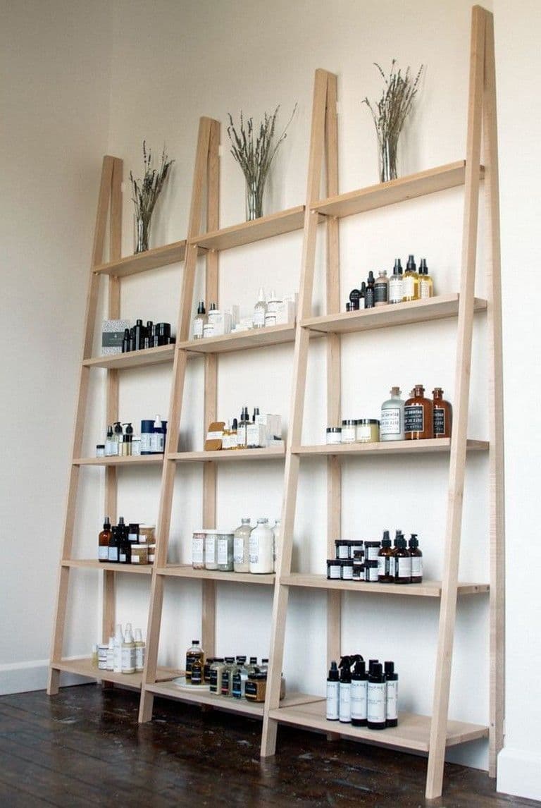Handmade ceramic vessels arranged on a minimalist stone shelf, warm natural light.